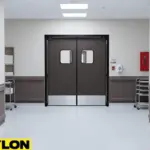 Clean medical hallway featuring heavy-duty swinging doors designed for reliable daily use in busy hospital corridors.