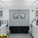 Double retail swinging doors behind the pharmacy counter supporting steady staff traffic