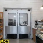 Double retail swinging doors connecting bakery prep room and front display area