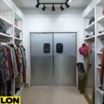 Gray PE-Series swinging doors in a boutique stores aisle with clothing and accessories
