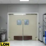 Laboratory with dual beige PE-Series swinging doors, chemical containers on shelves, and workspace for lab staff