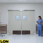 “Light-colored PE-620ALC swinging doors in a patient care zone, showing clean surfaces and two-way access for efficient hospital movement.”