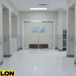 Light gray medical swinging door in a hospital hallway, providing hands-free passage and helping maintain cleanliness in high-traffic zones.