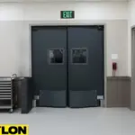 “PE-8000 heavy-duty swinging doors in a high-traffic hospital corridor, designed for equipment impact and reliable performance in medical environments.”