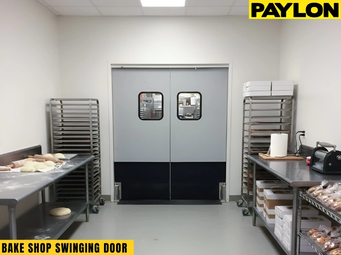 Retail swinging doors separating bake shop prep area from service space during busy hours