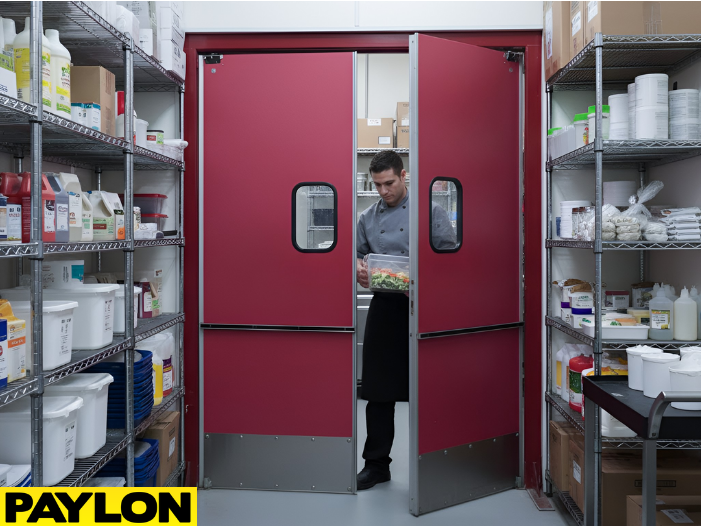Staff member carrying food through swinging doors in a busy pantry storage area
