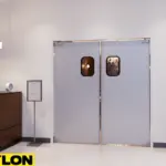 Swinging doors installed near a hotel front desk to control lobby traffic