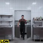 Employee walking through double swinging doors in a commercial bar, showing smooth movement between front and back service areas.