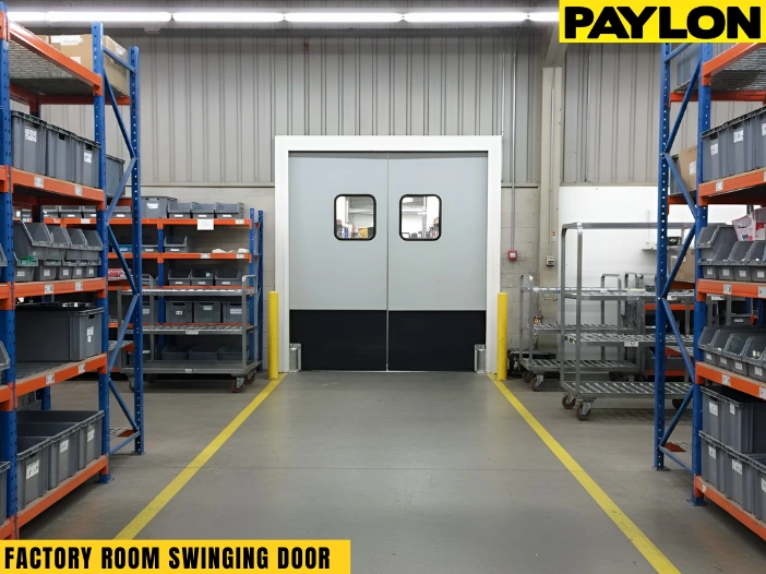 “Factory room swinging door installed between storage racks for smooth two-way traffic on the production floor.”