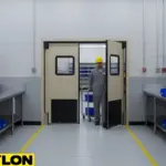 “Factory room swinging door with worker pushing materials, demonstrating two-way traffic efficiency on the production floor.”