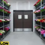 Floral storage cooler showing shelving of fresh flowers and commercial doors used during constant daily access
