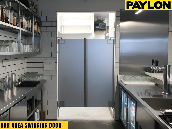 Gray bar area swinging doors installed between prep and service zones in a commercial bar, keeping staff movement smooth.