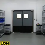 Heavy-duty swinging doors installed in an equipment storage room with clearly arranged shelves