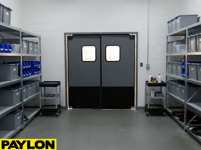 Heavy-duty swinging doors installed in an equipment storage room with clearly arranged shelves