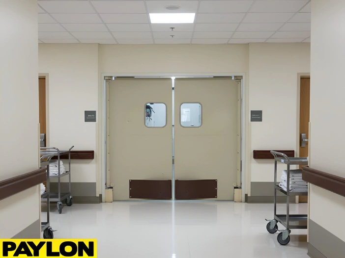 Nursing home corridor using swinging doors to manage shared movement of residents and care carts