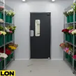 Small walk-in floral cooler layout with flower storage racks and a single access door for daily operations