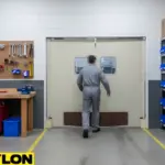 Technician approaching swinging doors between maintenance shop work zones