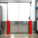 A commercial freezer door installed in a cold storage facility to reduce energy loss.