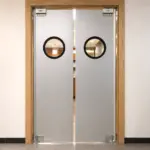A commercial kitchen swinging door with a viewport window, suitable for high-traffic food service environments.