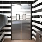 A double action swinging door suitable for food service environments, allowing hands-free passage in both directions.
