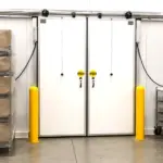 Energy efficient walk-in freezer door with polycarbonate panel installed on a commercial cold storage unit.
