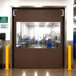 Flexible PVC strip door installed at a warehouse cooler entrance, allowing passage while maintaining temperature separation.