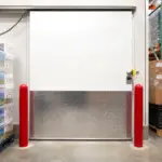 Heavy duty insulated sliding door installed on a commercial freezer in an industrial cold storage facility.