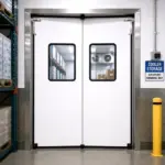 Heavy duty PVC swing door installed in a food processing facility, providing a hygienic barrier between production areas.