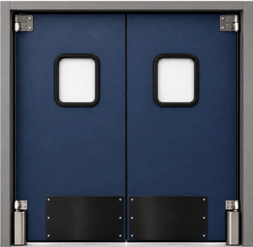PAYLON PEX impact swinging door installed in an industrial facility doorway for high-traffic forklift and pedestrian use.