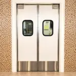 Impact resistant swinging doors installed in a high-traffic commercial or industrial facility doorway.