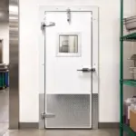 PAYLON PC cold air retention swinging door installed at the entrance of a commercial cooler or refrigerated space.