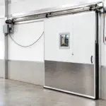 PAYLON PC cold air retention swinging door installed in a commercial refrigerated facility doorway.