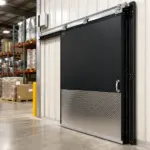 PAYLON PC-2000 insulated swinging door installed in a commercial facility to reduce energy loss between temperature-controlled areas.