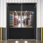 PE PVC swinging door installed at a storage warehouse entrance, allowing hands-free passage between areas.