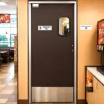 PAYLON PE-510 HPL high pressure laminate swinging door installed in a commercial or industrial facility.