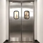 PE-510SS stainless steel swinging door installed in a commercial restaurant kitchen setting.