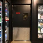 High-pressure laminate swinging door installed in a commercial kitchen environment.