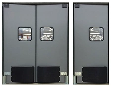 Heavy-duty industrial swinging doors installed in a commercial or warehouse facility entrance.
