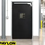 Durable PVC swinging doors installed at a warehouse entry point for high-traffic industrial use.