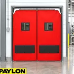 Flexible PVC swinging doors installed in an industrial facility to handle forklift and heavy vehicle traffic.