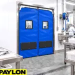 Heavy-duty swinging doors installed in a commercial or industrial facility to handle frequent cart and equipment traffic.