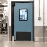 Insulated walk-in cooler door installed in an institutional school cafeteria setting.