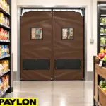 Self-closing PVC traffic doors installed in a commercial or industrial facility doorway for high-traffic passage.