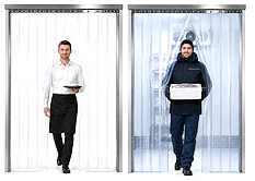 Clear strip PVC door hanging in an industrial doorway, providing a flexible barrier for forklifts and foot traffic.